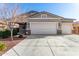 Attractive single-story home featuring a three-car garage, desert landscaping, and stone accents at 141 W Jamaica Pl, Casa Grande, AZ 85122