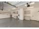 Spacious three-car garage featuring epoxy flooring, built-in cabinets, and ample storage space at 141 W Jamaica Pl, Casa Grande, AZ 85122