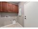 This laundry room has cabinets and utility connections at 141 W Jamaica Pl, Casa Grande, AZ 85122