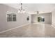 Bright, open living area with tile flooring, modern light fixtures, and sliding glass doors at 141 W Jamaica Pl, Casa Grande, AZ 85122