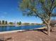 Picturesque pond view with a fountain, gazebo, and walking path against a clear blue sky at 141 W Jamaica Pl, Casa Grande, AZ 85122