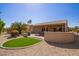 Beautiful backyard with a covered patio, artificial turf, and desert landscaping at 16016 W Indigo Ln, Surprise, AZ 85374