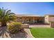 Spacious backyard featuring a covered patio, artificial turf, desert landscaping, and privacy at 16016 W Indigo Ln, Surprise, AZ 85374