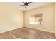 Inviting bedroom with wood-look floors and large windows, creating a bright, welcoming space at 16016 W Indigo Ln, Surprise, AZ 85374