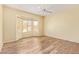 Spacious bedroom features bay windows for natural light and wood floors at 16016 W Indigo Ln, Surprise, AZ 85374