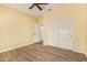 Bedroom with wood-look flooring, ceiling fan, and a closet with sliding doors at 16016 W Indigo Ln, Surprise, AZ 85374