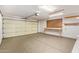 Clean, well-lit two car garage with ample space, pegboard and shelving at 16016 W Indigo Ln, Surprise, AZ 85374