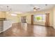 Open living space with wood floors, breakfast bar, and sliding glass door at 16016 W Indigo Ln, Surprise, AZ 85374