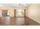 Living room with wood floors, sliding glass door, and windows showing the backyard patio at 16016 W Indigo Ln, Surprise, AZ 85374