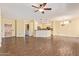 Open concept living room with wood floors leading to kitchen and front entryway at 16016 W Indigo Ln, Surprise, AZ 85374