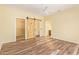 Charming main bedroom boasts wood floors, barn door access to walk-in closet, and en-suite bathroom at 16016 W Indigo Ln, Surprise, AZ 85374