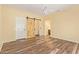 Charming main bedroom boasts wood floors, barn door access to walk-in closet, and en-suite bathroom at 16016 W Indigo Ln, Surprise, AZ 85374