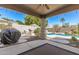 Inviting outdoor living space featuring a covered patio, a built-in barbecue, and a refreshing pool at 16601 S 16Th Dr, Phoenix, AZ 85045