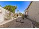 Landscaped backyard with gravel, desert plants, patio umbrella, and a glimpse of a pool at 16601 S 16Th Dr, Phoenix, AZ 85045