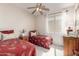Cozy bedroom showcasing two twin beds, a ceiling fan, and a side table at 16601 S 16Th Dr, Phoenix, AZ 85045