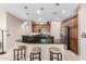 Modern kitchen with a granite countertop, stainless steel appliances, and breakfast bar seating at 16601 S 16Th Dr, Phoenix, AZ 85045