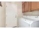 A laundry room featuring a newer washer and dryer, with storage cabinets at 16601 S 16Th Dr, Phoenix, AZ 85045