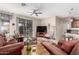 Spacious living room with comfortable leather seating and a sliding glass door to the patio at 16601 S 16Th Dr, Phoenix, AZ 85045
