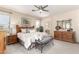 Spacious main bedroom featuring a ceiling fan, ample natural light, and an ensuite bathroom at 16601 S 16Th Dr, Phoenix, AZ 85045