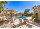 Relaxing patio area with stylish outdoor furniture, a cozy fire pit, and a clear view of the sparkling pool at 16601 S 16Th Dr, Phoenix, AZ 85045