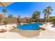 Inviting backyard pool with a stone surround and desert landscaping at 16601 S 16Th Dr, Phoenix, AZ 85045
