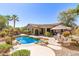 Inviting backyard pool area with lush landscaping, comfortable seating, and serene desert ambiance at 16601 S 16Th Dr, Phoenix, AZ 85045