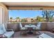 Outdoor covered patio featuring lounge chairs, a table, and a view of the complex at 1720 E Thunderbird Rd # 2090, Phoenix, AZ 85022