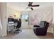Bedroom with carpet, a computer desk, a black gaming chair and a comfortable looking recliner at 1720 E Thunderbird Rd # 2090, Phoenix, AZ 85022