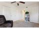 Carpeted bedroom with a large closet, an inviting chair, and ceiling fan at 1720 E Thunderbird Rd # 2090, Phoenix, AZ 85022