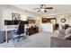 Cozy living room with a home office, comfortable seating, and modern ceiling fan at 1720 E Thunderbird Rd # 2090, Phoenix, AZ 85022