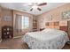 Inviting bedroom with natural light, ceiling fan, and floral bedding at 1784 S 236Th Dr, Buckeye, AZ 85326