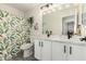 Bathroom featuring a double sink vanity with white marble countertops and black hardware at 1883 E Tremaine Ave, Gilbert, AZ 85234