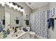 This full bathroom features a single vanity with a framed mirror and tub with shower at 19035 N 83Rd Ln, Peoria, AZ 85382