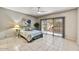 This bright bedroom features a ceiling fan and large sliding doors to the backyard at 19035 N 83Rd Ln, Peoria, AZ 85382