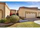 Charming home exterior with a well-maintained lawn, a two car garage, and desert landscaping at 19035 N 83Rd Ln, Peoria, AZ 85382