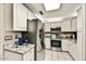 Bright kitchen featuring granite countertops, stainless steel appliances, and white cabinets at 19035 N 83Rd Ln, Peoria, AZ 85382