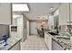 Open kitchen with tiled flooring, white cabinets, granite countertops, and stainless steel appliances at 19035 N 83Rd Ln, Peoria, AZ 85382