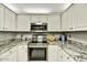 Close up of a kitchen boasting granite countertops, stainless steel appliances, and ample cabinet space at 19035 N 83Rd Ln, Peoria, AZ 85382