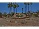 Stunning landscaping design with custom concrete clock and desert foliage at 19035 N 83Rd Ln, Peoria, AZ 85382