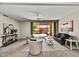 Bright living room with sliding doors to a patio, neutral toned walls, and contemporary furnishings at 19035 N 83Rd Ln, Peoria, AZ 85382