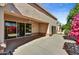 This covered patio has sliding glass doors and a view of the lush landscaping at 19035 N 83Rd Ln, Peoria, AZ 85382