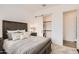 Comfortable main bedroom with a sliding barn door leading to closet and laundry machines at 21919 E Lords Ct, Queen Creek, AZ 85142