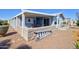 Backyard view with a small wall and an outdoor dining set on the covered patio at 2263 N Trekell Rd # 21, Casa Grande, AZ 85122