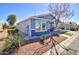 Side view of light blue home showing manicured landscaping and bright, sunny day at 2263 N Trekell Rd # 21, Casa Grande, AZ 85122
