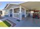Single story home with a golf cart under the carport and a lovely front porch at 2263 N Trekell Rd # 21, Casa Grande, AZ 85122