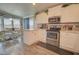 Bright kitchen featuring white cabinets, stainless steel appliances, and dining area with natural light at 2263 N Trekell Rd # 21, Casa Grande, AZ 85122