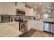 Well-lit kitchen with white cabinetry, stainless steel appliances, and functional countertop space at 2263 N Trekell Rd # 21, Casa Grande, AZ 85122