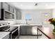 A newly remodeled kitchen featuring stainless steel appliances, grey cabinetry, and light countertops at 2277 S Apache Dr # 7, Apache Junction, AZ 85120