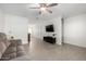 Bright living room featuring tile floors, ceiling fan, contemporary furniture, and a mounted television at 2277 S Apache Dr # 7, Apache Junction, AZ 85120