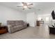 Comfortable living room with tile floors, ceiling fan, comfortable sofa, and open concept at 2277 S Apache Dr # 7, Apache Junction, AZ 85120